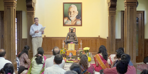 Dennis welcoming devotees
