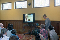devotees watching video presentation, image 2