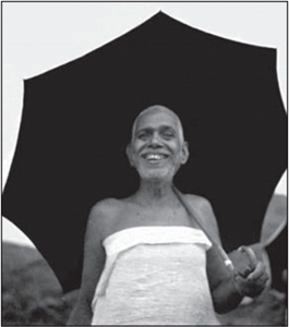 Bhagavan with umbrella, smiling