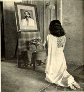 Rival holy man, Sri Aurobindu's ashrama is in neighvoring Pondichery. A woman dressed in a sari kneels in prayer before a photograph of the master.