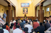 devotees reciting; image facing the shrine